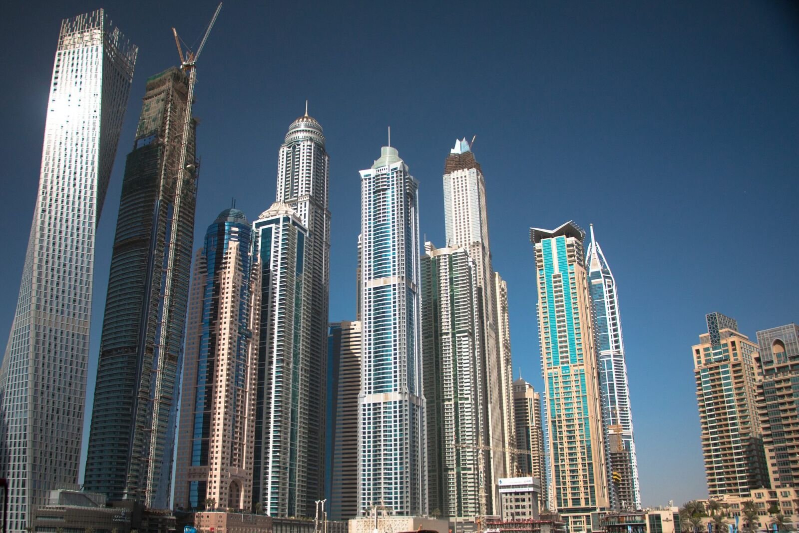Construction site in Dubai with cranes and a concrete frame rising