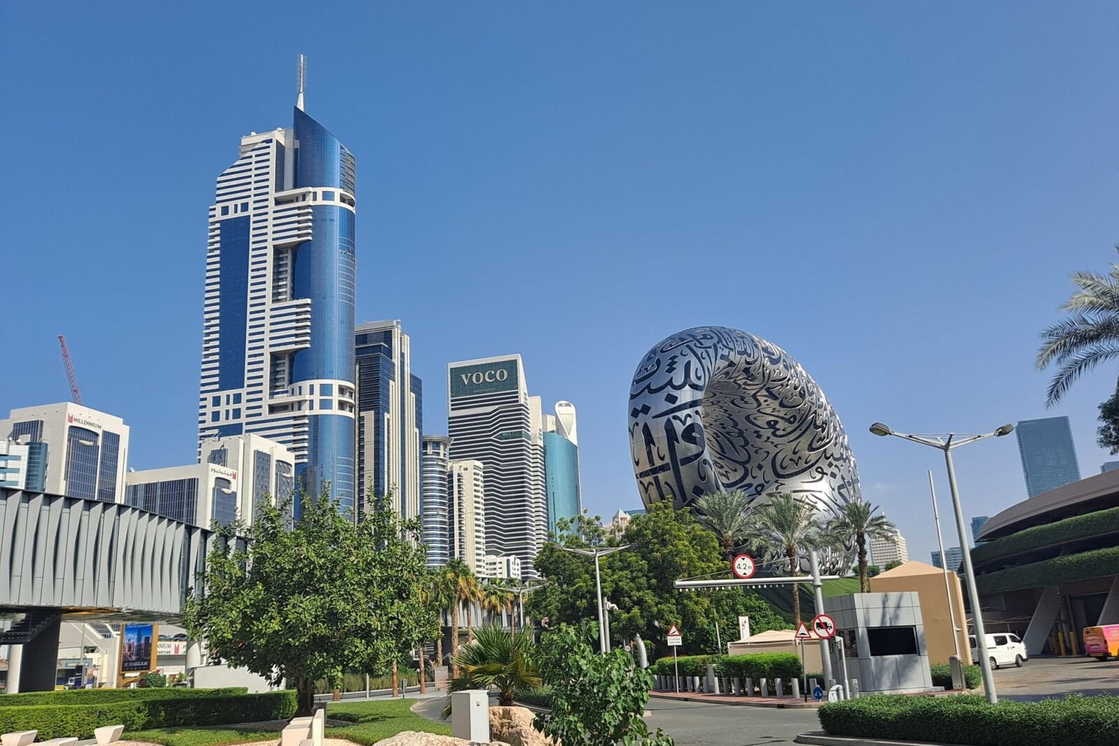 Museum of the Future on Sheikh Zayed Road in Dubai, with palm trees and office towers